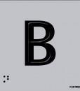 Letra B mayscula en negro sobre fondo aluminio gris y en braille