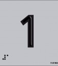 Número 1 en negro sobre fondo gris y braille en aluminio