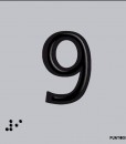 Número 9 en negro sobre fondo gris y braille en aluminio